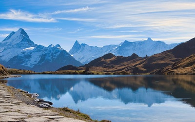 an image of a lake beneath a mountain